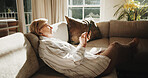 Typing, sofa and senior woman with phone, social media and message for internet connection. Retirement, home and person on cellphone for contact, digital puzzle and website search in living room