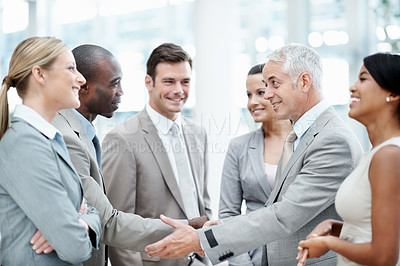 Buy stock photo Business people, meeting and handshake with client in office, laughing and agreement for investment. Corporate, team and shaking hands with investor, partnership and happy for funding opportunity