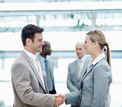 Buy stock photo Corporate, happy and business people with handshake in office for agreement, merger and b2b deal. Team, professional and man with woman shaking hands for financial partnership, welcome and thank you
