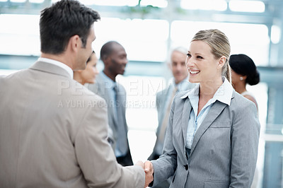 Buy stock photo Lobby, meeting and business people with handshake in office for agreement, welcome and partnership. Finance, conference and man with woman shaking hands for teamwork, collaboration and thank you