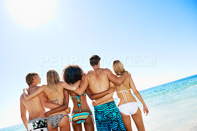 Buy stock photo Outdoor, travel and hug with friends at beach, mockup space or bonding with group on summer vacation. Sea, back and embrace with people on coastal holiday, support and adventure together in nature