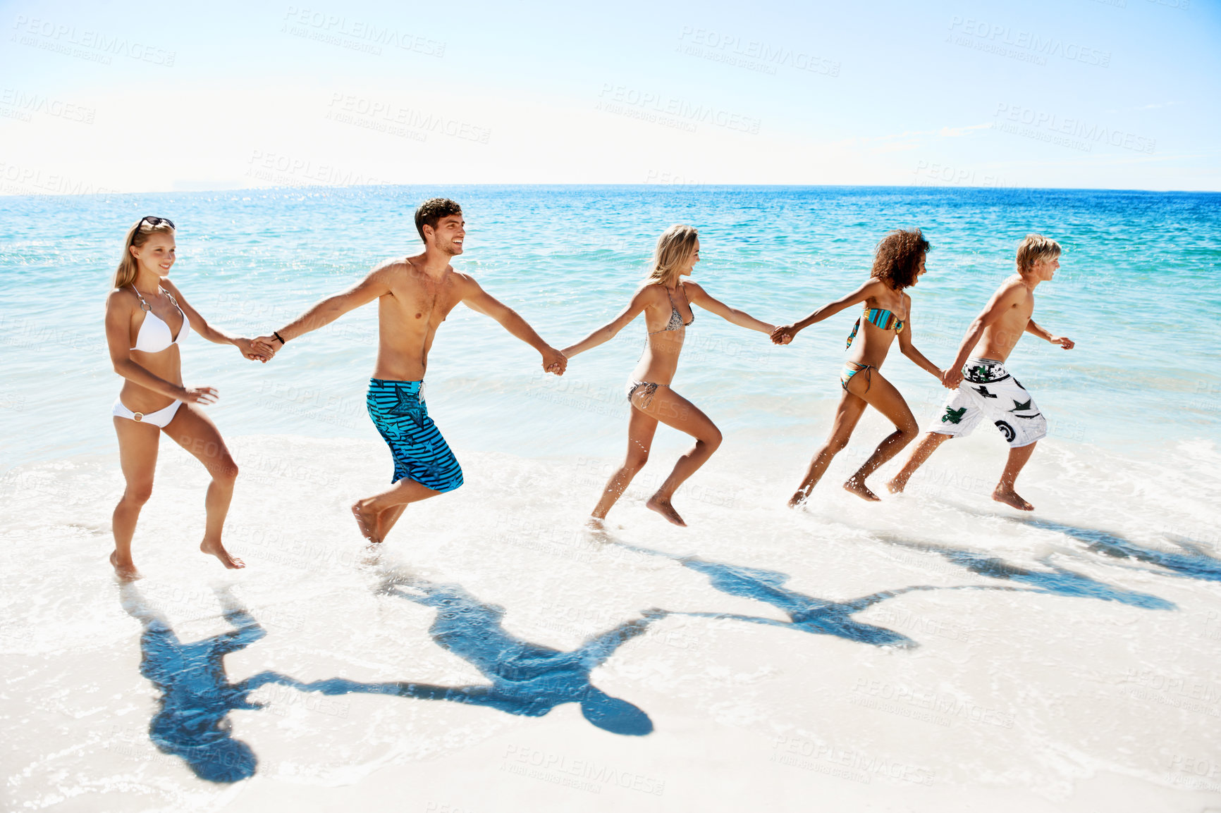 Buy stock photo Waves, running and friends holding hands at beach for summer vacation, holiday and weekend. Happy, space and women with men by ocean for bonding, tourism and travel for island adventure together