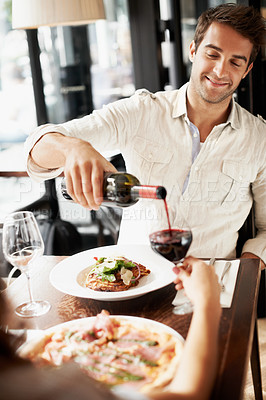 Buy stock photo Man, couple or pour wine in restaurant with love, valentines day or lunch date with smile. Happy, people and offer drink in diner for anniversary milestone, gentleman gesture or fine dining with food