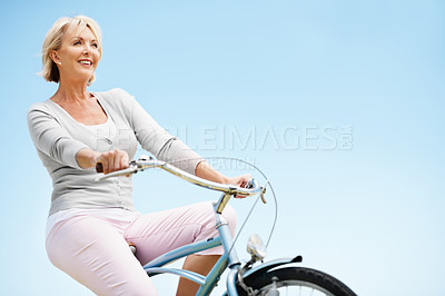 Buy stock photo Fun, smile and woman outdoor with bicycle, positive attitude and happy moment in weekend activity. Wellness, mockup space and mature person with confidence, good mood and enjoyment in cycling hobby.