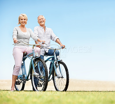 Buy stock photo Park, bicycle and travel with senior couple, portrait and fitness with mockup space on vacation. Happy man, woman and bike outdoor for cycling, exercise or active retirement for wellness on holiday