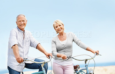 Buy stock photo Beach, bike and smile with senior couple, portrait and fitness with partner on vacation. Happy man, woman and bicycle outdoor for cycling, exercise and active retirement for longevity on holiday