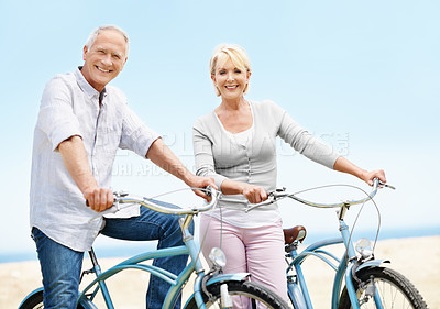 Buy stock photo Beach, bicycle and travel with elderly couple, portrait or fitness with partner on vacation. Happy man, woman and bike outdoor for cycling, exercise and active retirement for wellness on holiday