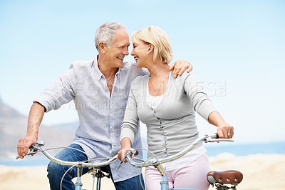 Buy stock photo Cycling, outdoor and senior couple with bicycle, laugh and bonding with partner and travel together. Happy, old people and trip with eco friendly transport, love and connection with spouse in nature