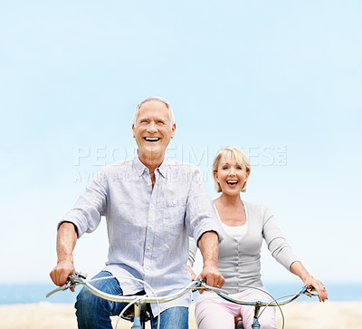 Buy stock photo Mature, travel or happy couple with bicycle in nature for outdoor ride, commute or holiday together. Excited, man and woman with smile or laughing on bike for fun weekend, bonding or trip in park