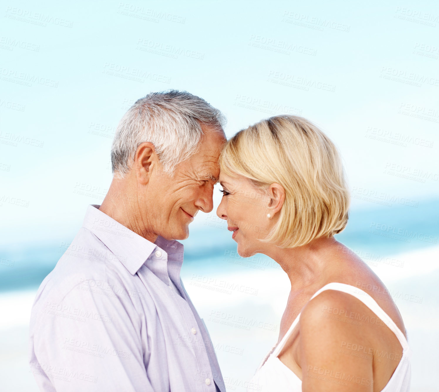 Buy stock photo Happy, beach and couple with forehead touch for bonding, love and connection on summer vacation. Smile, care and mature man with woman for affection in marriage by ocean on holiday or weekend trip.