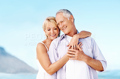 Buy stock photo Smile, hug and couple by beach with love on summer vacation, getaway or weekend trip together. Happy, care and mature woman embracing man with safety, bonding or connection by ocean on holiday.