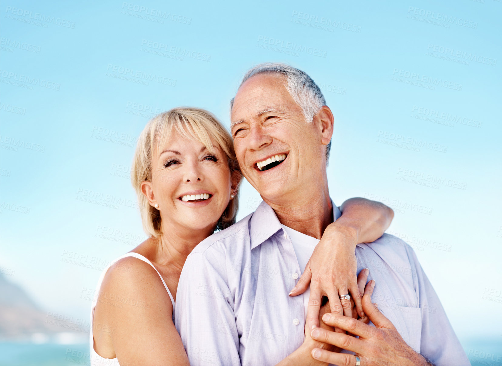 Buy stock photo Laugh, hug and mature couple at beach with affection for marriage, relationship and holiday together. Happy, travel and man with woman by ocean for summer vacation, weekend and embrace for bonding