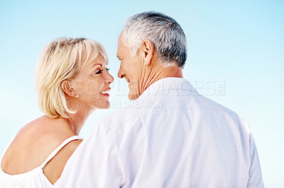 Buy stock photo Happy, space and couple outdoor on holiday, getaway or weekend trip together for bonding. Smile, love and mature woman with man by blue sky for connection, commitment or care in marriage on vacation.