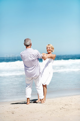 Buy stock photo Holding hands, spin and happy couple at beach for love, marriage and playful relationship. Travel, smile and mature man with woman by ocean for summer holiday, vacation and anniversary for bonding