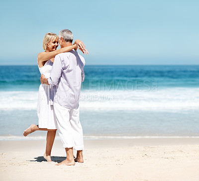 Buy stock photo Love, hug and couple by beach for vacation, getaway or weekend trip together in summer. Smile, space and mature woman embracing man with safety, bonding or connection in marriage by ocean on holiday.
