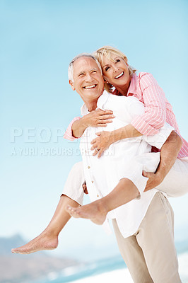 Buy stock photo Holiday, love or elderly couple at beach with piggyback, bonding or happy moment on trip. Smile, space or senior people with fun, romantic relationship or playful connection on outdoor getaway.