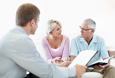 Buy stock photo Notebook, advice and financial advisor with old couple in home for retirement plan, wealth management and profit. Insurance payout, budget and broker with senior man and woman for joint account