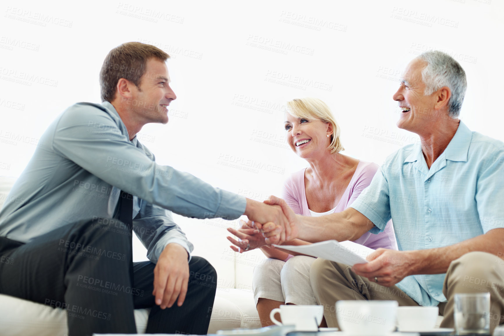 Buy stock photo Finance, old couple or advisor in home with handshake, investment deal or loan approval in retirement. Happy, senior people or consultant with shaking hands, credit offer or agreement on pension fund