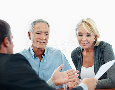 Buy stock photo Happy, senior couple and meeting with financial advisor, talking or listening to retirement strategy. Old people, smile and estate planning with wealth manager, explaining and advice with document
