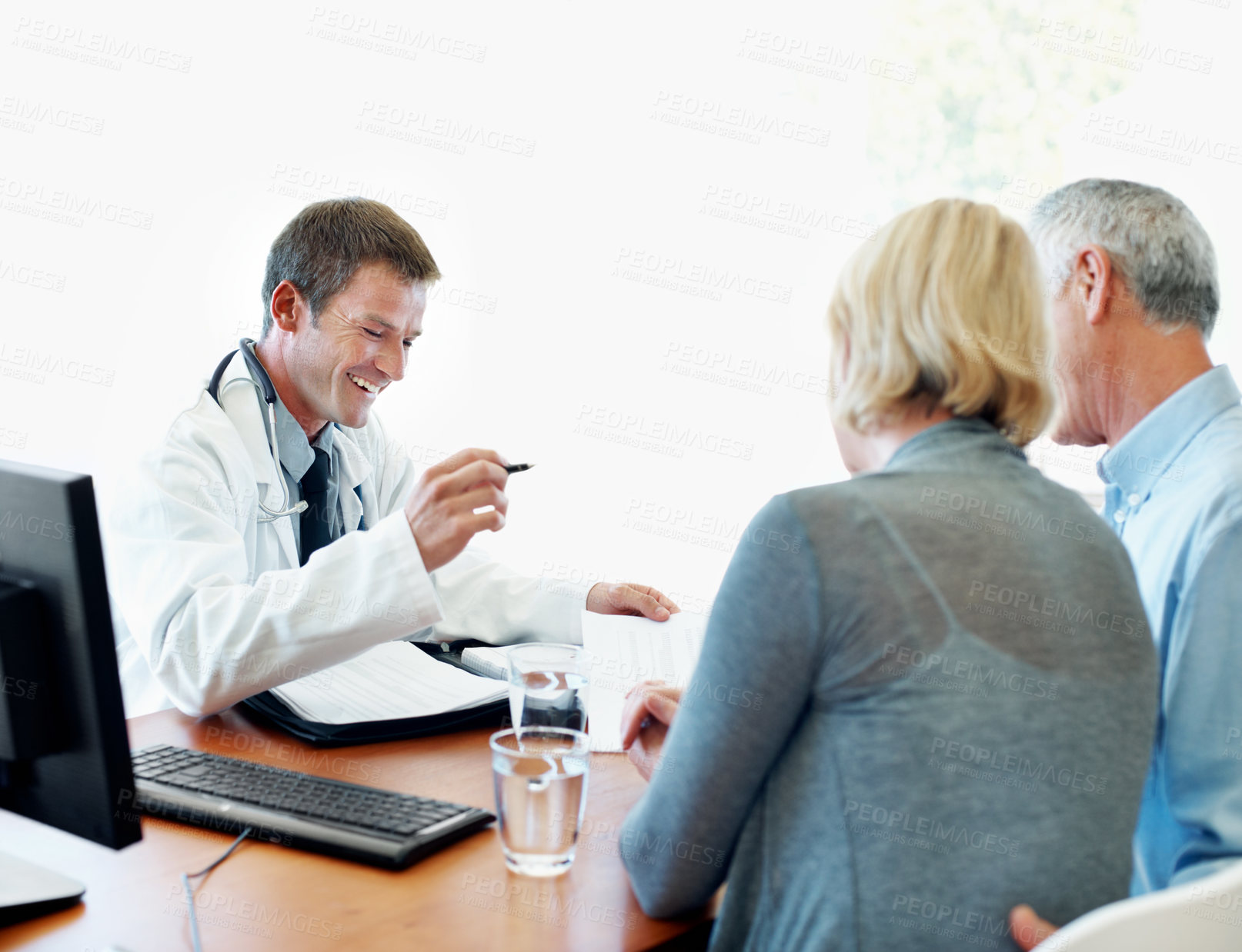 Buy stock photo Happy, doctor and insurance with senior couple for healthcare service, assistance or registration. Elderly, man and woman with health worker, smile or application for medical aid or cover in hospital