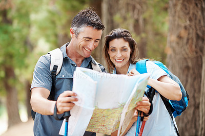 Buy stock photo Map, forest and happy couple with hiking navigation for outdoor destination or route in wilderness. Man, woman or hikers with tour guide for trekking path, direction or travel together in nature