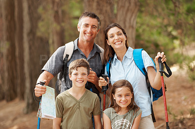 Buy stock photo Hiking, smile and portrait of family in nature for adventure, exploring or bonding on holiday. Happy, support and parents with children in forest for trekking on vacation, getaway or weekend trip.