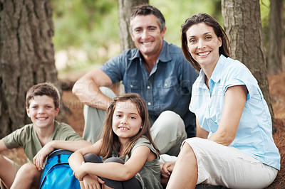 Buy stock photo Portrait, forest and happy family with break for hiking trip, outdoor adventure or rest in nature. Mom, dad and children with smile or recovery in wilderness for trekking, travel or bonding together