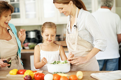 Buy stock photo Cooking, grandmother and child with mom in kitchen for learning, mixing salad and help with lunch. Food, generations and happy girl with ingredients, vegetables and healthy dinner in family home