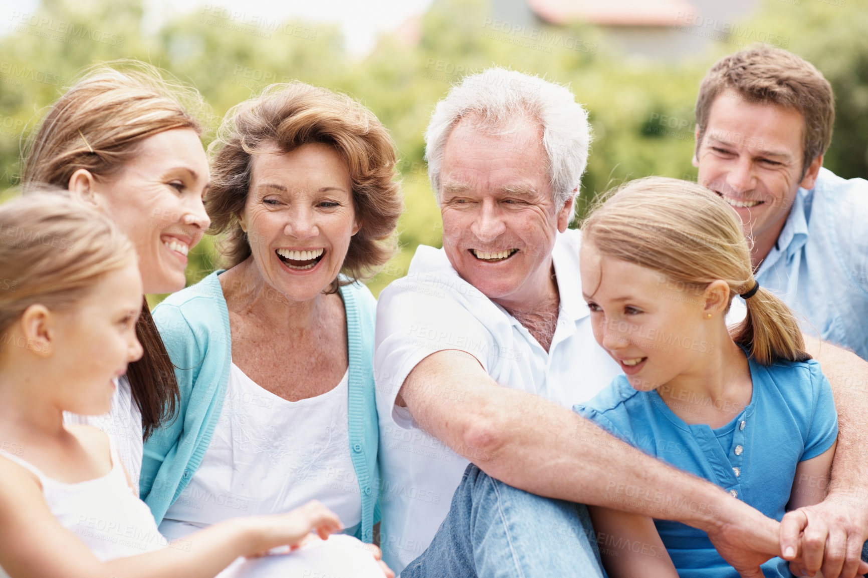 Buy stock photo Grandparents, parents and children in backyard with laugh, generations together and joke for bonding. Happy family, mature people and kids outdoor with humor for connection, good mood and wellness.