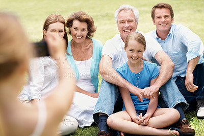 Buy stock photo Smile, garden and child with family for picture, memory and relax together outdoor. Camera, park and girl with photo of parents, grandparents and children for bonding, connection and photograph
