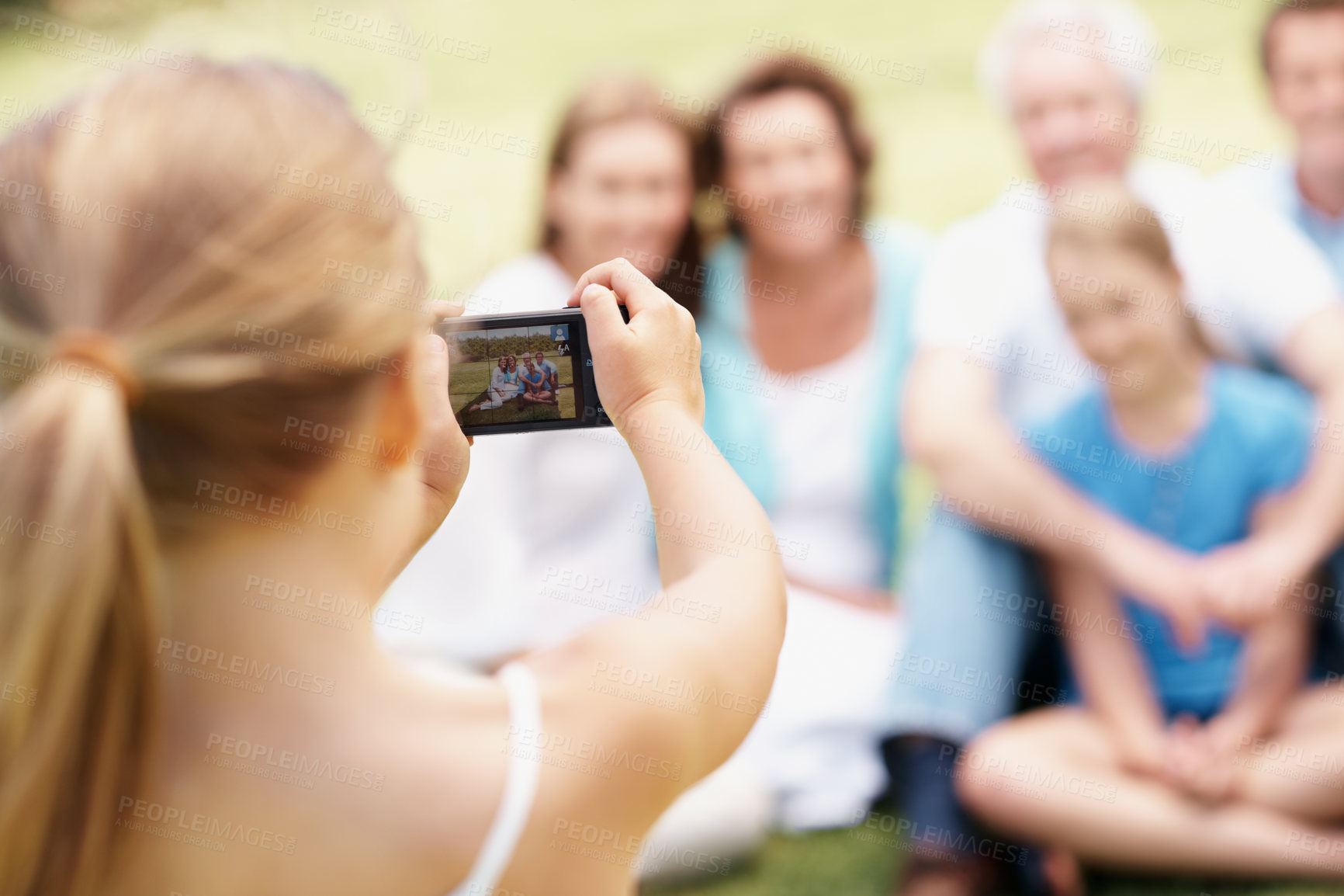 Buy stock photo Camera, backyard and child with family for picture, memory and relax together outdoor. Screen, park and girl with photo of parents, grandparents and children for bonding, connection and photograph
