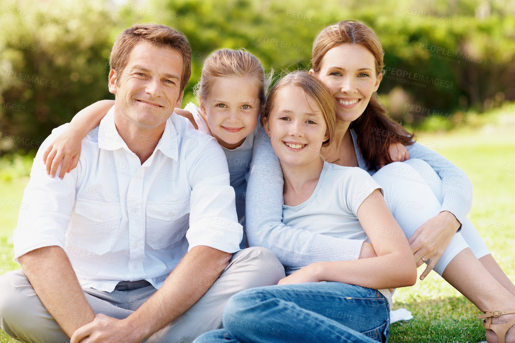 Buy stock photo Portrait, parents and kids in park with hug, relax together and smile for family connection on weekend. Happy people, mother and father chill outdoor with children, embrace and good mood for bonding.