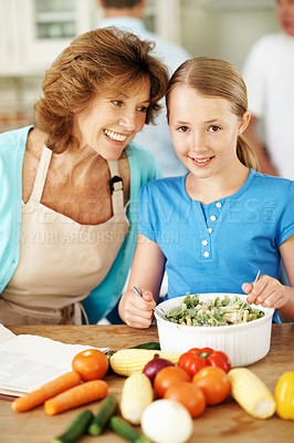 Buy stock photo Cooking, child and happy grandmother with salad in home for help, support or teaching family recipe. Meal prep, grandma and kid with learning in portrait for culinary skills, healthy food or bonding