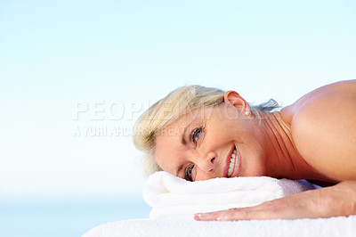 Buy stock photo Happy, senior woman and relax on massage table at spa, health and luxury treatment for stress relief. Resort, wellness and mature person with smile on break, body care and resting on holiday or space