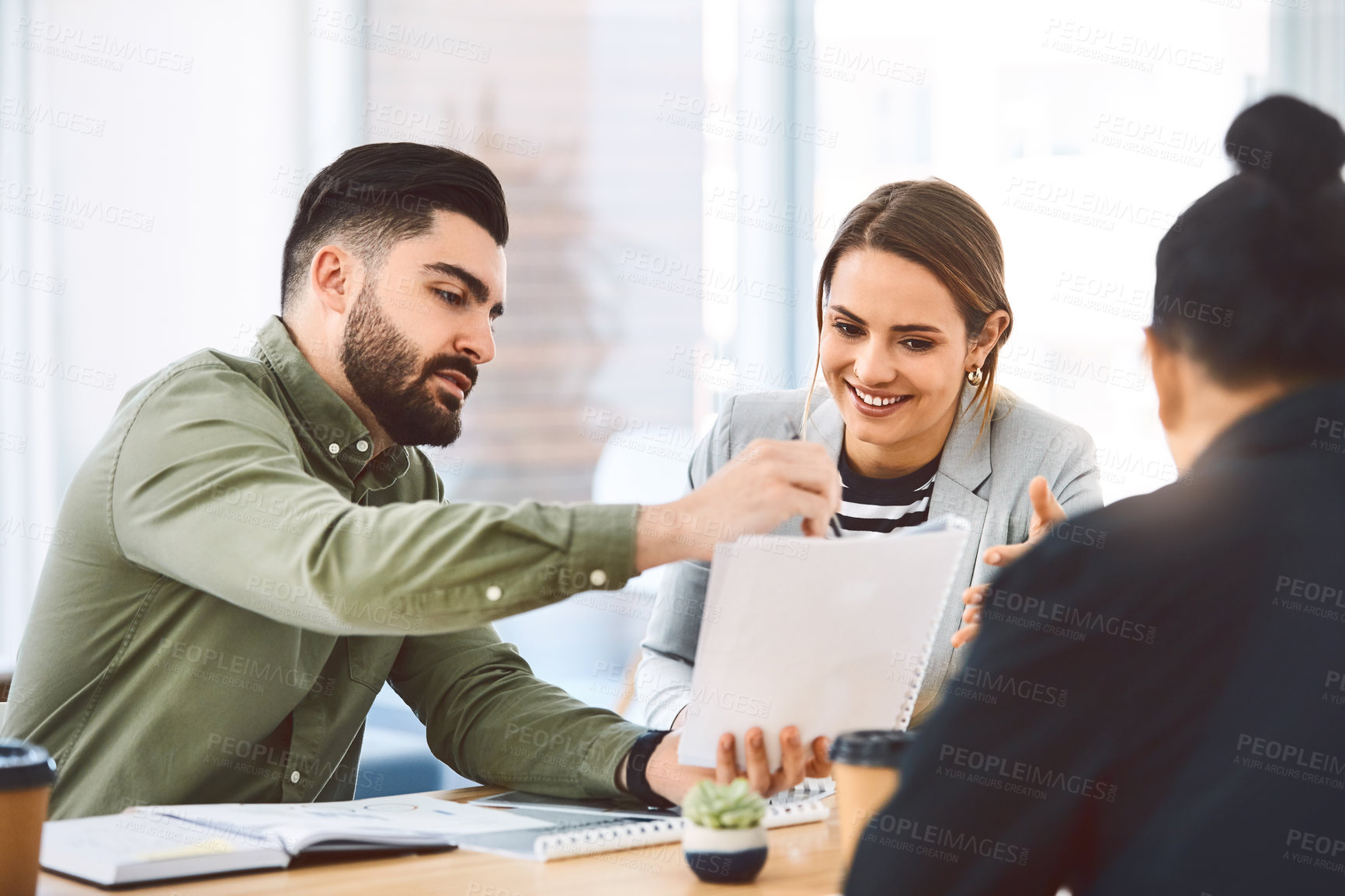 Buy stock photo Shot of a group of young businesspeople having a meeting in a modern office