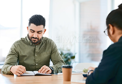 Buy stock photo Shot of two young businessmen having a meeting in a modern office