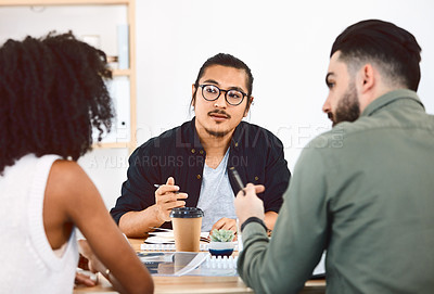Buy stock photo Shot of a group of young businesspeople having a meeting in a modern office