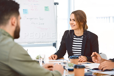 Buy stock photo Shot of a group of young businesspeople having a meeting in a modern office