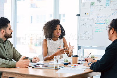 Buy stock photo Shot of a group of young businesspeople having a meeting in a modern office