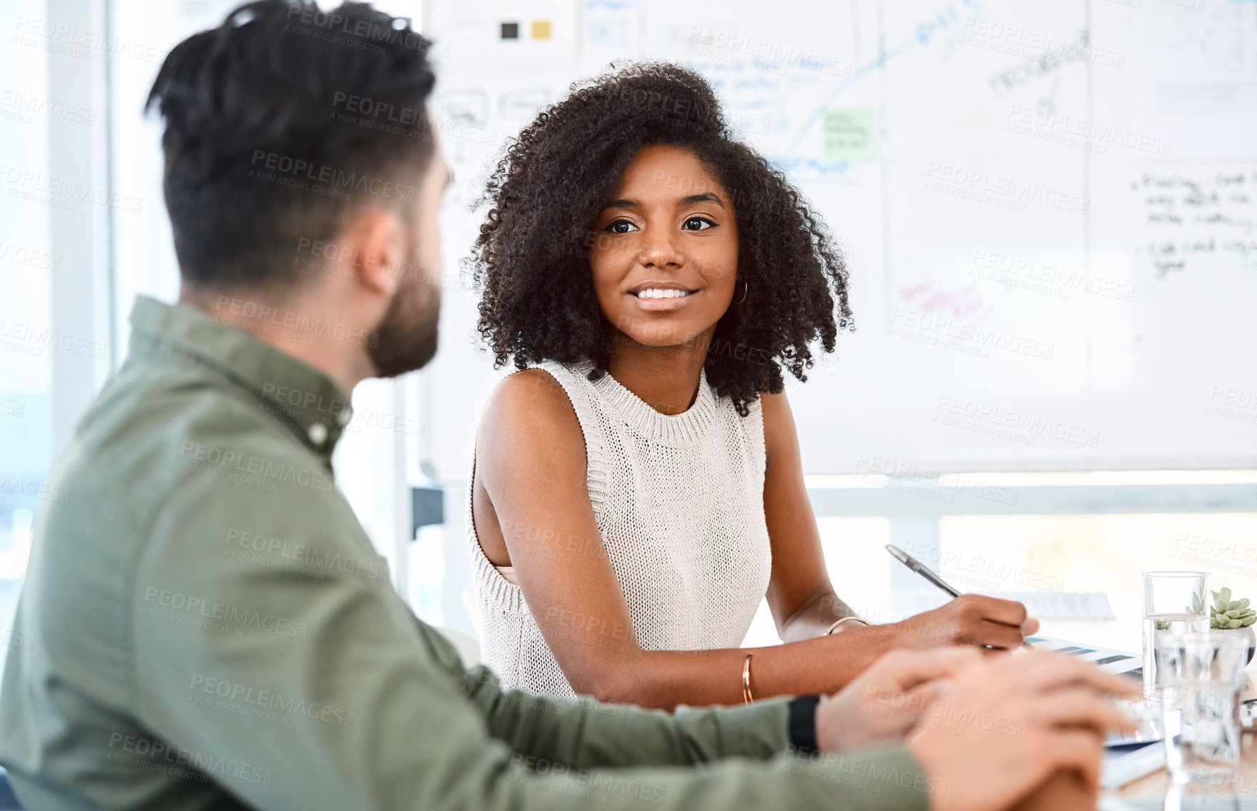 Buy stock photo Shot of a young businessman and businesswoman having a meeting in a modern office