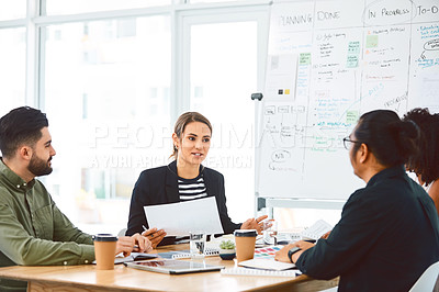 Buy stock photo Shot of a group of young businesspeople having a meeting in a modern office