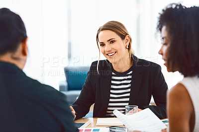 Buy stock photo Shot of a group of young businesspeople having a meeting in a modern office