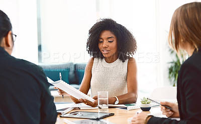 Buy stock photo Shot of a group of young businesspeople having a meeting in a modern office