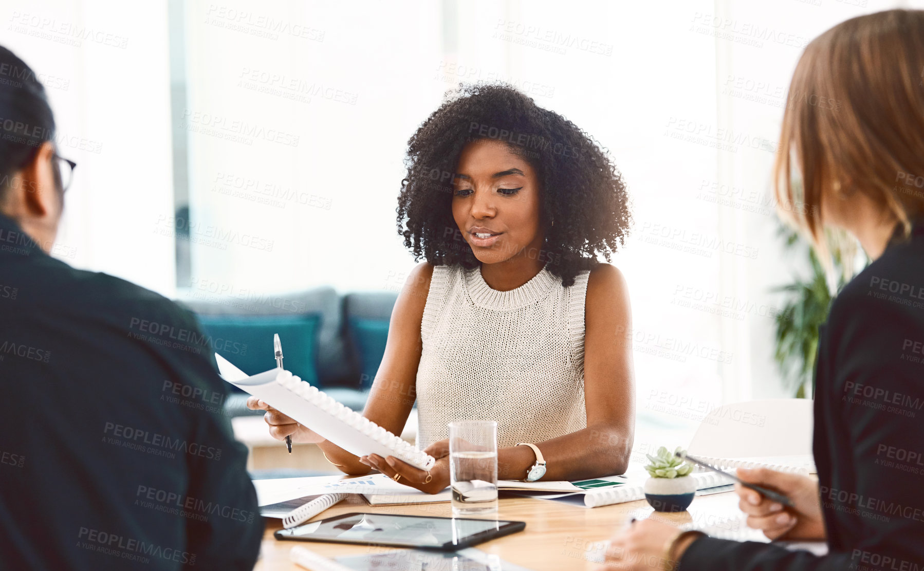 Buy stock photo Shot of a group of young businesspeople having a meeting in a modern office