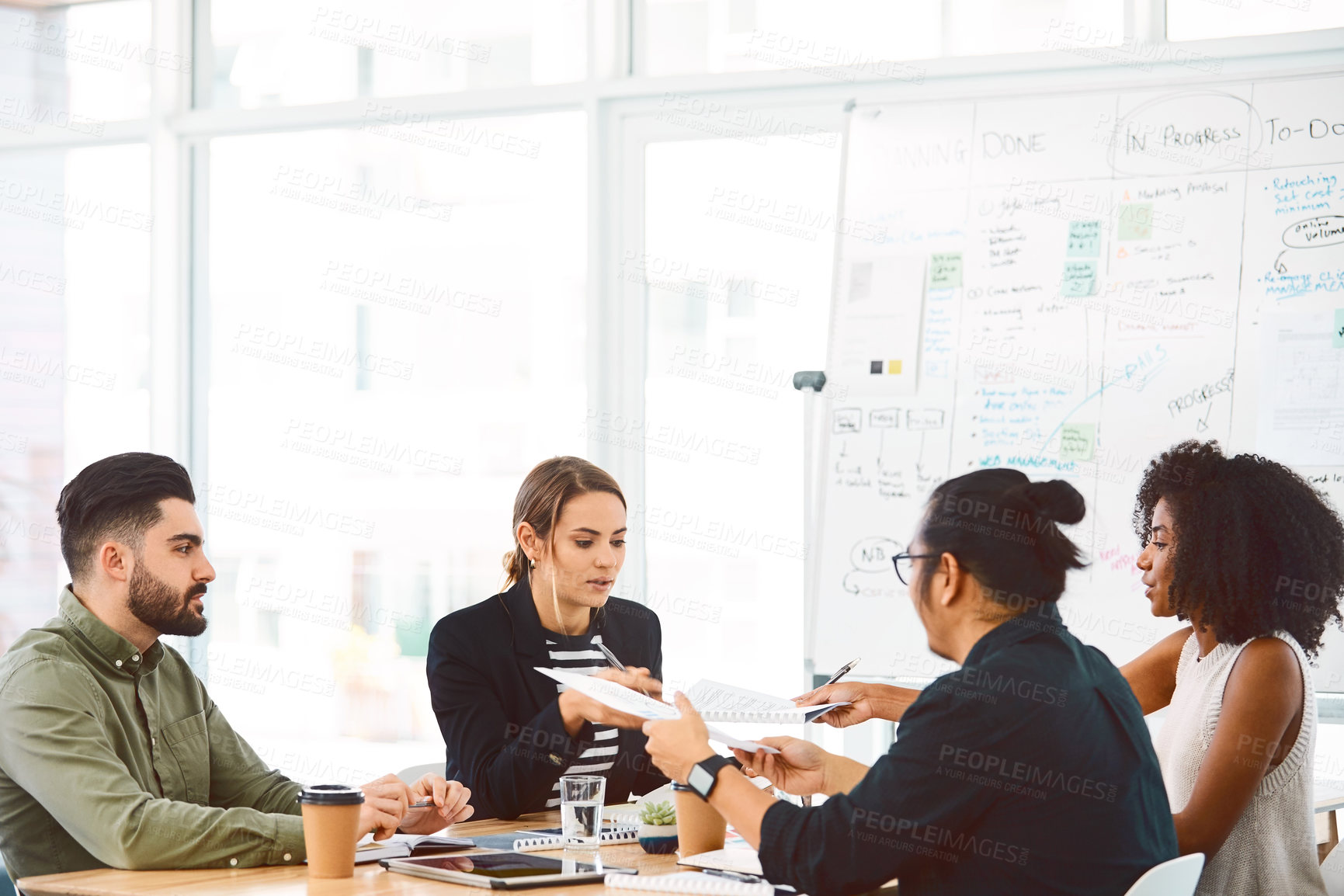 Buy stock photo Shot of a group of young businesspeople having a meeting in a modern office