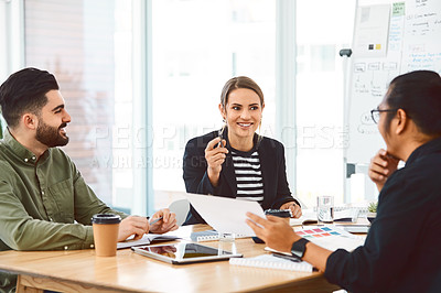 Buy stock photo Shot of a group of young businesspeople having a meeting in a modern office