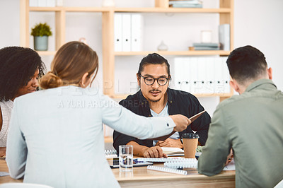 Buy stock photo Shot of a group of young businesspeople having a meeting in a modern office
