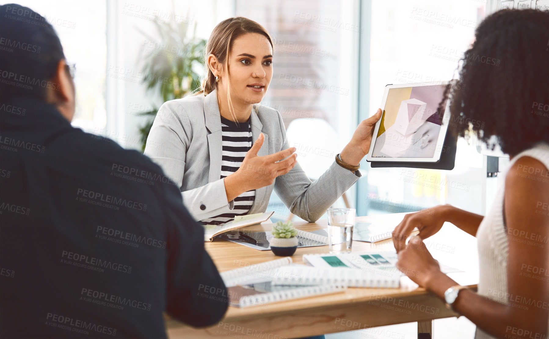 Buy stock photo Woman, tablet screen and discussion with creative team in office, graphic design or brand identity. Planning, tech and collaboration in meeting with people, logo layout and show progress update