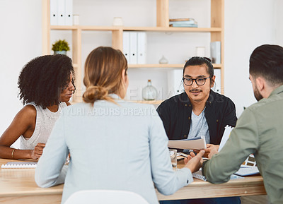 Buy stock photo Shot of a group of young businesspeople having a meeting in a modern office