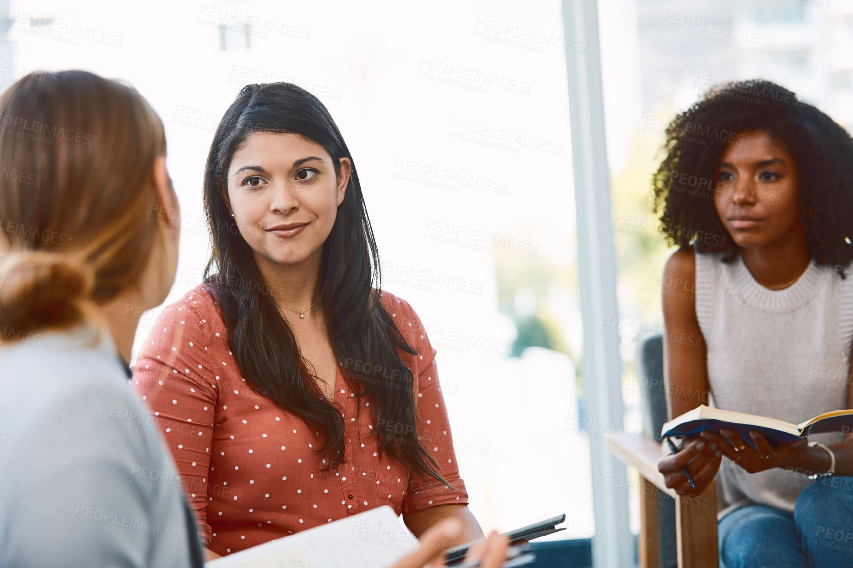 Buy stock photo Shot of a group of young businesspeople having a meeting in a modern office